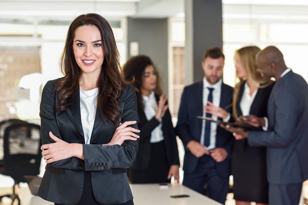 businesswoman-leader-in-modern-office-with-businesspeople-workin-1920w